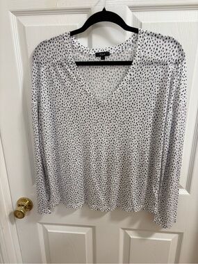 Rails long sleeve V-neck linen top in a white and black spotted print.,